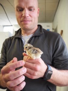 Brandon Jackson holds a baby bird