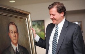 President Reveley examines the recently found portrait of his great-grandfather Thomas Eason, who taught biology at Longwood.