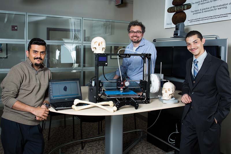 Amir Mosley ’15 (right) researched 3-D printing  technology with help from Muneeb Mobashar (left)  of the Digital Education Collaborative and biology professor Dr. Björn Ludwar.