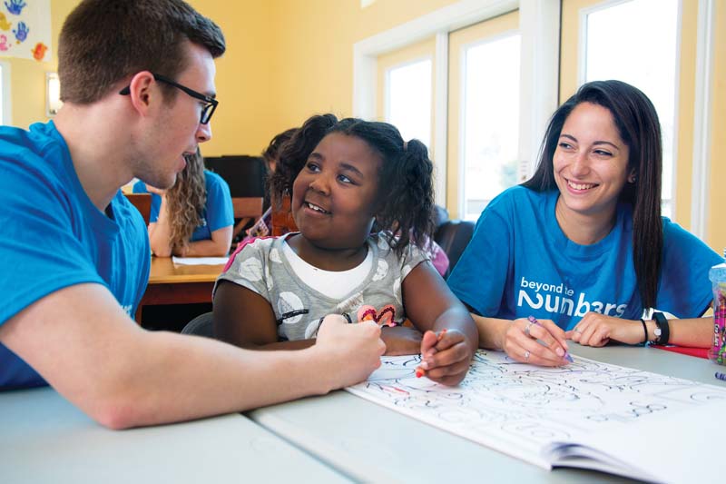 Andrew Law ’17 and Gaby Tirado ’18 chat and color with Makyia Johnson, 6.