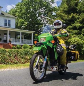 Perkins rides his Kawasaki dual-sport bike in front of his 110-year-old home in Prospect.