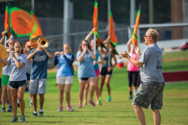 Rob Blankenship ’00 keeps time while his Douglas Freeman High School marching band prepares for the coming year at band camp in August.