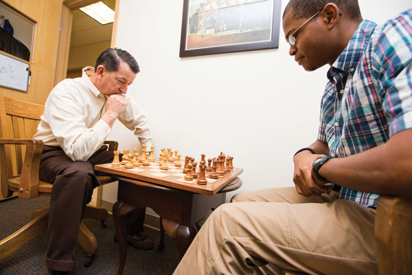Physics professor and former Cook-Cole College of Arts and Sciences Dean Chuck Ross considers an opening move against senior history major Alex Morton.