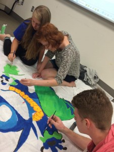 painting the banner for the Honors Student Association's Oktoberfest booth